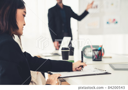 Businesswoman in business meeting writing paper proficiently at office room . Businesswoman in business meeting writing paper proficiently at office room . 84200543