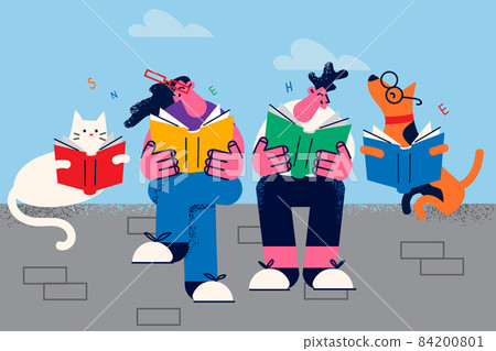 Happy couple with pets enjoy reading books 84200801