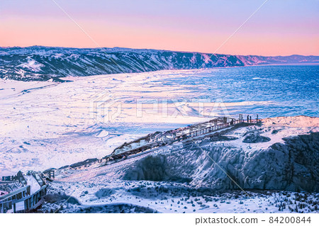 Winter wonderland and Christmas fantasy landscape. Frozen sea coast and mountains covered with snow as holiday background 84200844