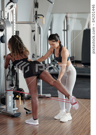 Woman Doing Exercise with Resistance Band Woman Doing Exercise with Resistance Band 84201446