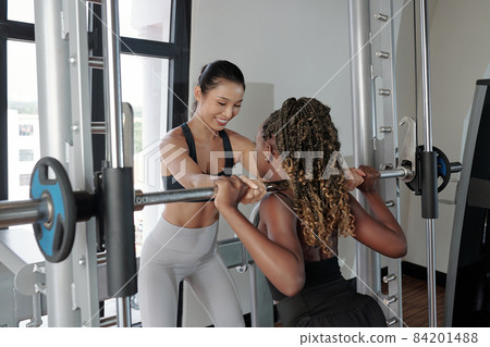 Trainer Explaining Client How to Hold Barbel 84201488