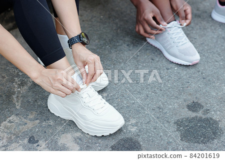 Sportswomen Tying Shoelace Sportswomen Tying Shoelace 84201619