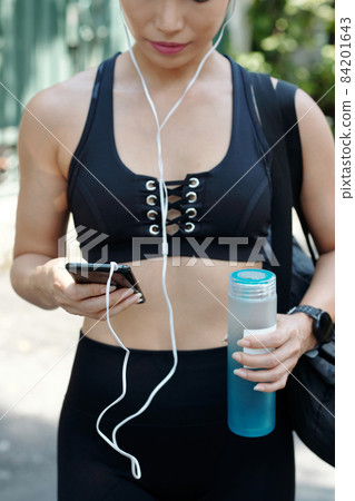 Sportswoman Setting Music for Training Sportswoman Setting Music for Training 84201643