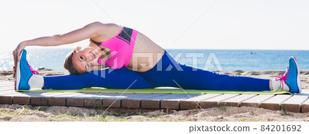 Adult female is stretching 84201692