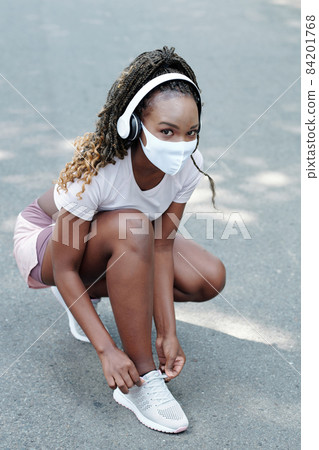 Pretty Female Jogger Tying Shoe Laces Pretty Female Jogger Tying Shoe Laces 84201768