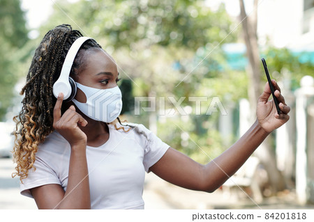 Woman in Medical Mask Taking Selfie Woman in Medical Mask Taking Selfie 84201818