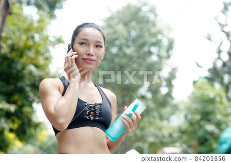 Female Jogger Talking on Phone Female Jogger Talking on Phone 84201856