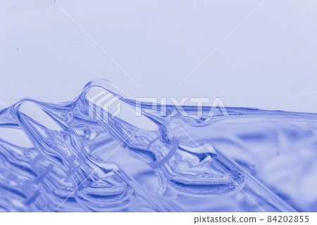 Glass medical ampoule vial for injection. Medicine is liquid sodium chloride with of aqueous solution in ampulla. Close up. Bottles ampule multicolor. 84202855