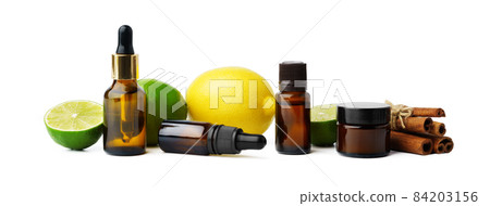 Essential oil bottles and citrus fruit on white background 84203156