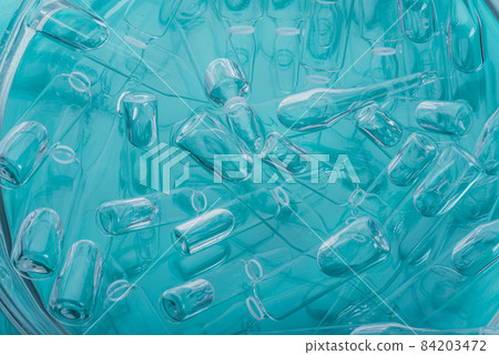 Glass medical ampoule vial for injection. Medicine is liquid sodium chloride with of aqueous solution in ampulla. Close up. Bottles ampule multicolor. Glass medical ampoule vial for injection. Medicine is liquid sodium chloride with of aqueous solution in ampulla. Close up. Bottles ampule multicolor. 84203472