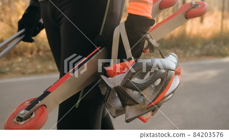 Training an athlete on the roller skaters. Biathlon ride on the 84203576