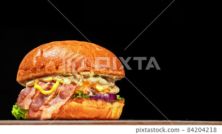 Craft burger is cooking on black background. Consist: sauce, let 84204218