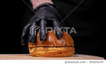 Craft burger is cooking on black background. Consist: sauce, let 84204244