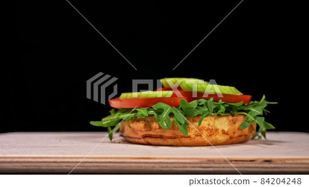 Craft burger is cooking on black background. Consist: sauce, aru Craft burger is cooking on black background. Consist: sauce, aru 84204248