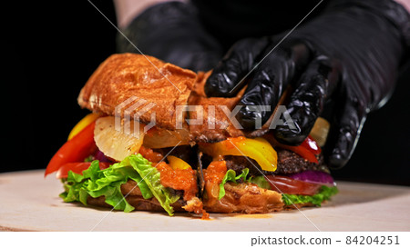 Cut craft burger is cooking. Consist: red sauce salsa, lettuce, Cut craft burger is cooking. Consist: red sauce salsa, lettuce, 84204251