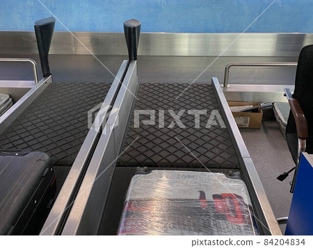 Packed suitcases in protective film on transport tape Packed suitcases in protective film on transport tape 84204834