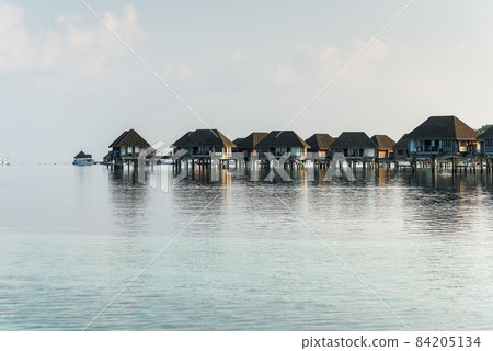 Tropical island with Water-Bungalows on the Maldives 84205134