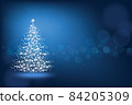 Abstract Christmas tree made of snowflakes and sparks on a blue blank background 84205309