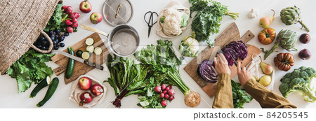 Female cutting fresh vegan ingredient for healthy Female cutting fresh vegan ingredient for healthy 84205545