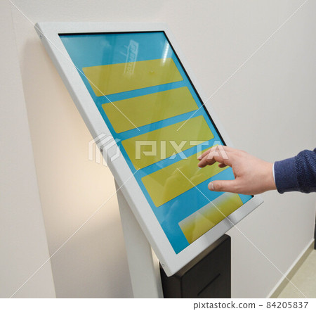 Man orders food in the touch screen terminal with electronic menu in fastfood restaurant. Modern technology concept 84205837