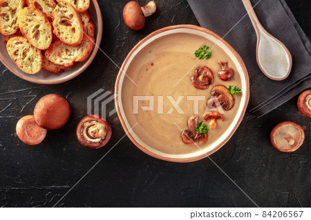 Mushroom soup with ingredients and toasted bread, shot from the top Mushroom soup with ingredients and toasted bread, shot from the top 84206567