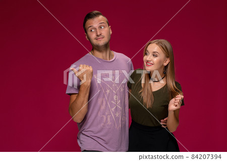 People, friendship, love and leisure concept - lovely couple with thumbs-up gesture on burgundy background 84207394