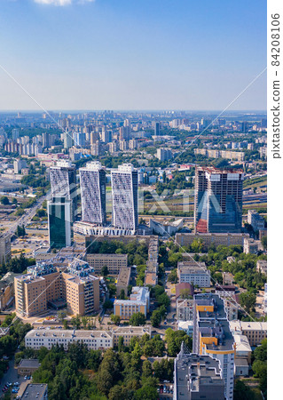 Aerial photography, urban residential areas and green parks in the summer blue haze and sunlight. Vertical image. Aerial photography, urban residential areas and green parks in the summer blue haze and sunlight. Vertical image. 84208106