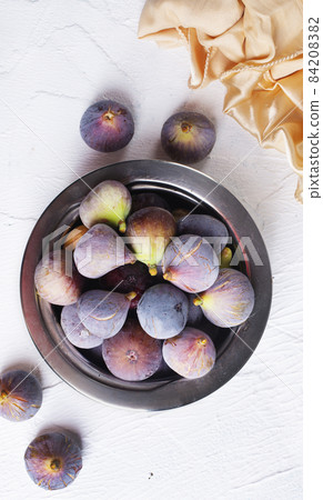 Portion of fresh Figs on light background Portion of fresh Figs on light background 84208382