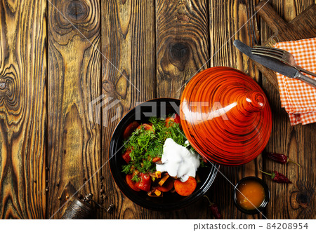 Mixed roasted vegetables with thyme in tagine. Mixed roasted vegetables with thyme in tagine. 84208954