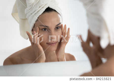Happy young hispanic woman satisfied with eyes area. 84213821