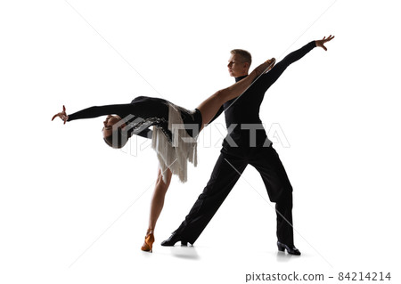 Two young graceful dancers, flexible man and woman dancing ballroom dance isolated on white studio background. 84214214