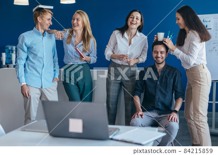 Group of young people standing in class during recess and laughing 84215859