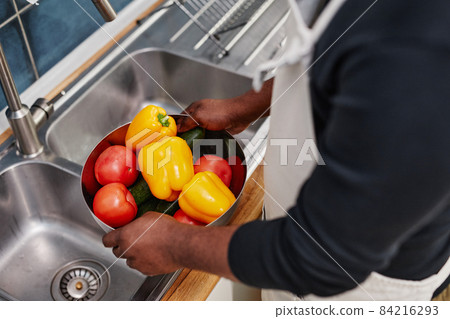 Man Washing Fresh Vegetables 84216293