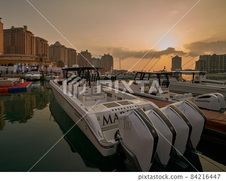 The pearl Marina in Porto Arabia in Doha, Qatar daylight view with Yachts in foreground, buildings and clouds in the sky in background The pearl Marina in Porto Arabia in Doha, Qatar daylight view with Yachts in foreground, buildings and clouds in the sky in background 84216447