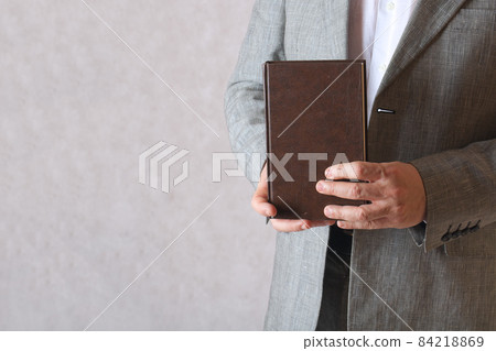 A book in a man's hands. Closeup A book in a man's hands. Closeup 84218869
