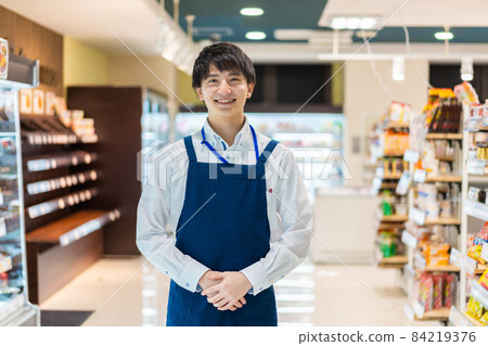 Young male staff working in a food supermarket 84219376