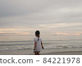 Little girl playing on sand beach coast seashore with sunset for imagination outdoor self learning 84221978