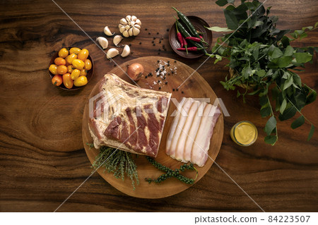 smoked fatty bacon on rustic wood table with natural ingredients 84223507