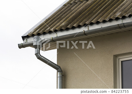 Corner of a house with a steel gutter system 84223755