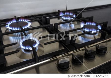Closeup shot of fire from gas kitchen stove. Closeup shot of fire from gas kitchen stove. 84223766