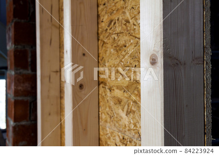 Close up detail of house construction wooden wall elements. Interior frame renovation work Close up detail of house construction wooden wall elements. Interior frame renovation work 84223924