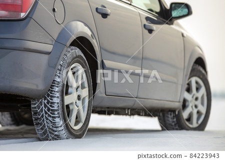 Car parked on snowy road on winter day. Transportation, vehicles design and safety concept. Car parked on snowy road on winter day. Transportation, vehicles design and safety concept. 84223943