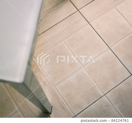 tiled floor in the kitchen with iron and glass table 84224761