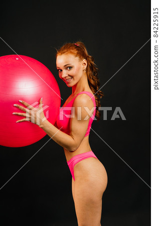 Portrait of seductive young woman looking at camera with muscular body ready for a workout Portrait of seductive young woman looking at camera with muscular body ready for a workout 84225915