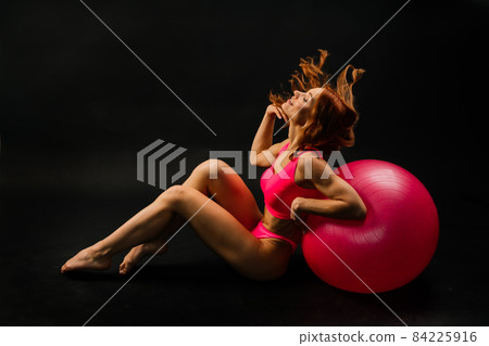 Portrait of seductive young woman looking at camera with muscular body ready for a workout Portrait of seductive young woman looking at camera with muscular body ready for a workout 84225916