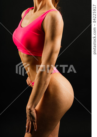 Portrait of seductive young woman looking at camera with muscular body ready for a workout Portrait of seductive young woman looking at camera with muscular body ready for a workout 84225917