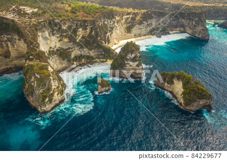 Aerial shot at sea with turquoise water and rocks. Atuh beach, Nusa Penida, Bali, Indonesia. 84229677