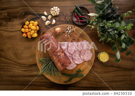 garlic ham sausage on rustic wood table with natural ingredients garlic ham sausage on rustic wood table with natural ingredients 84230310