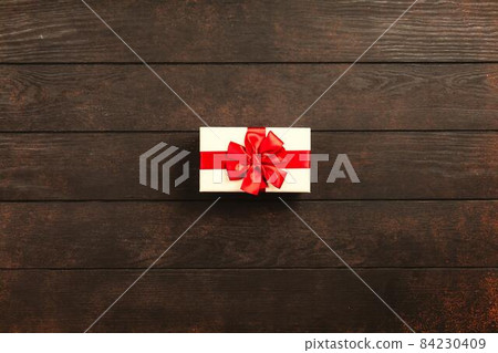 Christmas background with gift boxes on wooden table Christmas background with gift boxes on wooden table 84230409