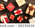 Christmas background with gift boxes on wooden table 84230416